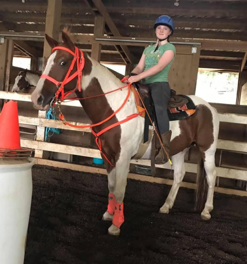 Cheyanne Greene poses with Cherokee, Son Rise Ranch&rsquo;s longtime mustang who died May 18 at 40, in an undated photo. (Contributed by Pam Cronkhite)