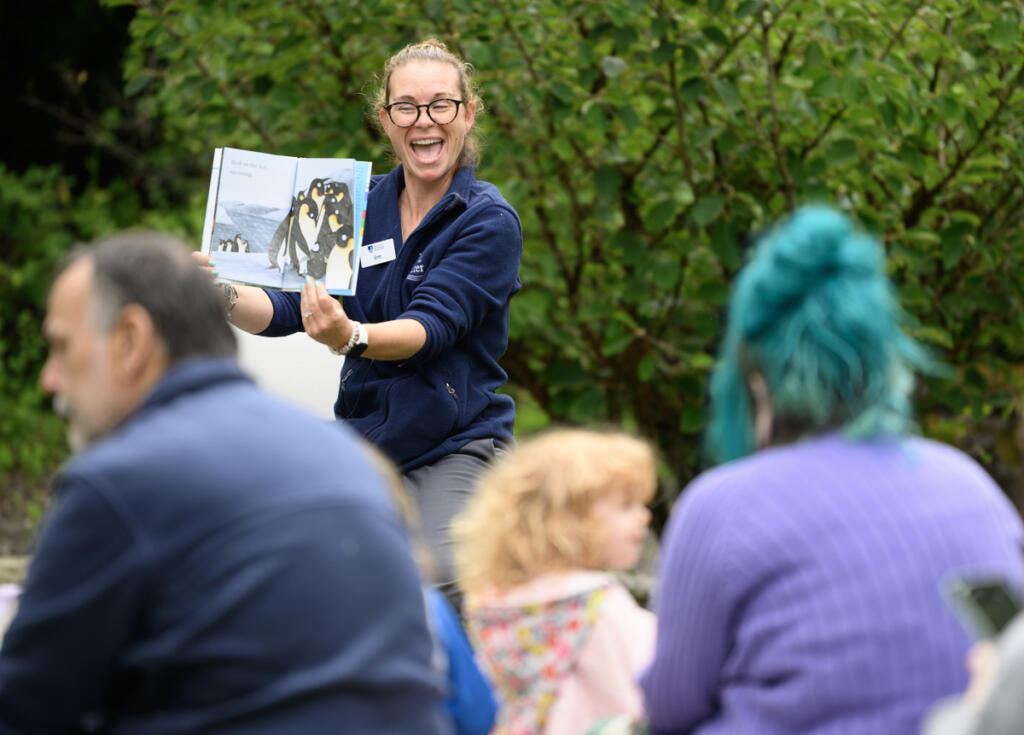 Educator Erin Bowen reads a story to adults and children on a Wednesday during a Reading in the Wild event at the Water Resources Education Center in Vancouver. (Taylor Balkom/The Columbian)
