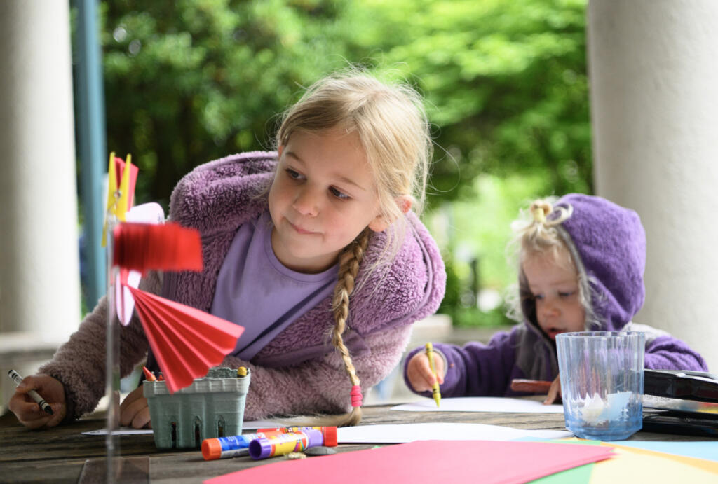Hazel, left, 6, and sister Willow Bendt, 2, work on making paper birds during a Reading in the Wild event.