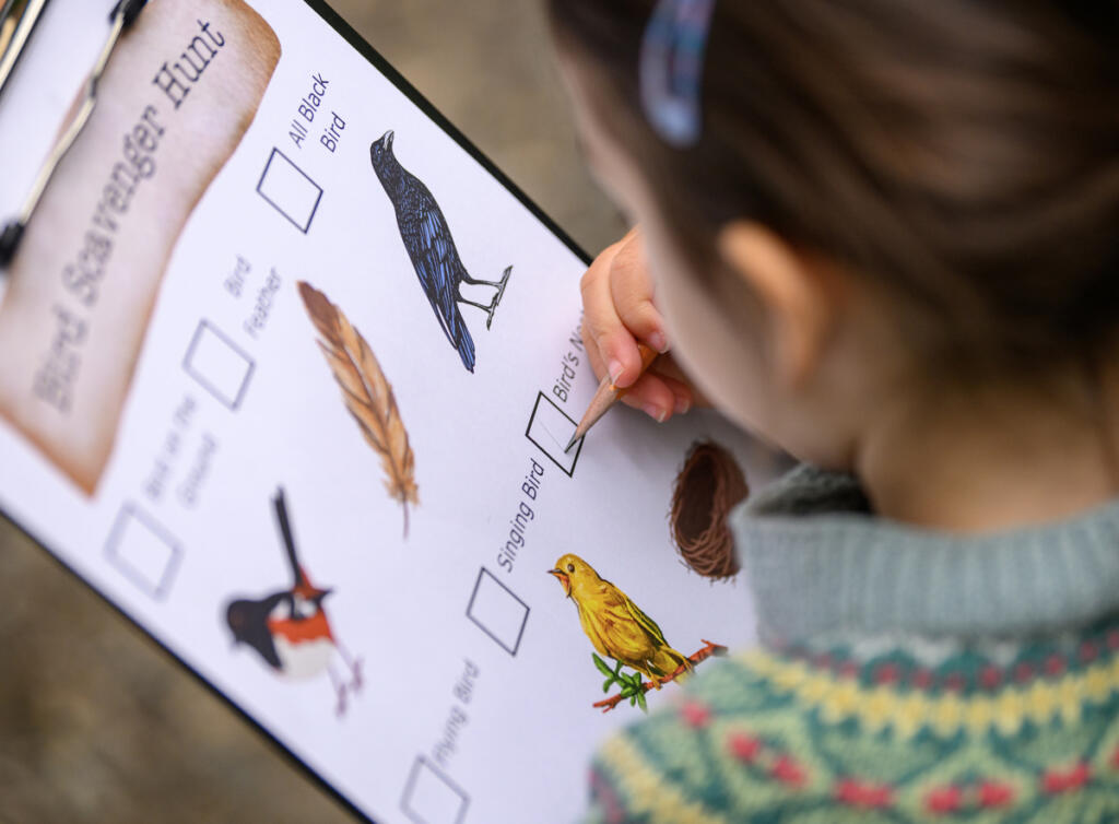Penelope Eakin, 4, checks off a box on a scavenger hunt clipboard Wednesday during a Reading in the Wild event at the Water Resources Education Center in Vancouver. (Taylor Balkom/The Columbian)