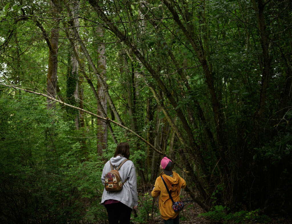 A pair look for birds during a scavenger hunt Wednesday during a Reading in the Wild event at the Water Resources Education Center in Vancouver. (Taylor Balkom/The Columbian)