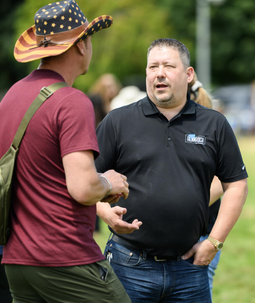 Brent Hennrich speaks with a community member July 3 during an America 250 celebration at Fort Vancouver National Historic Site. (Taylor Balkom/The Columbian)