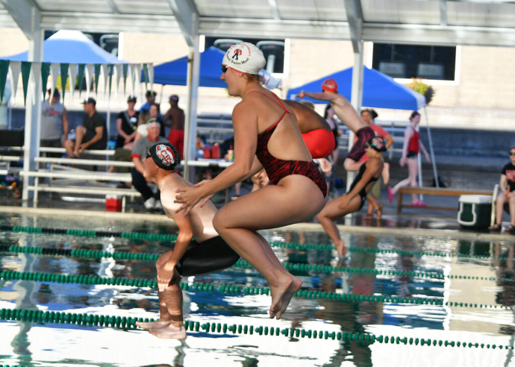 Competitors jump off the blocks with a cannonball dive to start the 200-meter freestyle at the Camas High Alumni swim meet Friday at Gold&rsquo;s Gym Camas. (Tim Martinez/The Columbian)