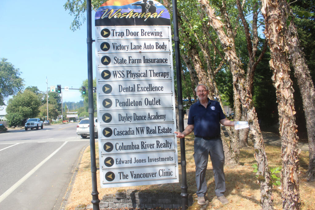 Washougal Business Association President Paul Greenlee on Aug. 1, 2024, at the city of Washougal&rsquo;s wayfinding sign on Main Street. Greenlee, the late president of the Washougal Business Association, claimed that the sign was outdated and could be improved. (Doug Flanagan/The Columbian)