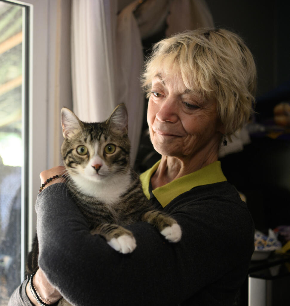 In-home care aide Vicki Bickford holds her cat Pippin on Tuesday at her home in Vancouver. Bickford said WA Cares &ldquo;is going to keep people safe in their home instead of living in a car.&rdquo;