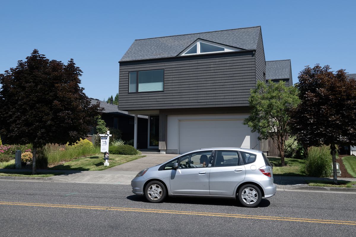 A motorist drives past a home for sale in Ridgefield on Monday morning. As the war in Iran rages on, inflation and interest rates remain high, keeping many buyers out of the real estate market. (Photos by Amanda Cowan/The Columbian)