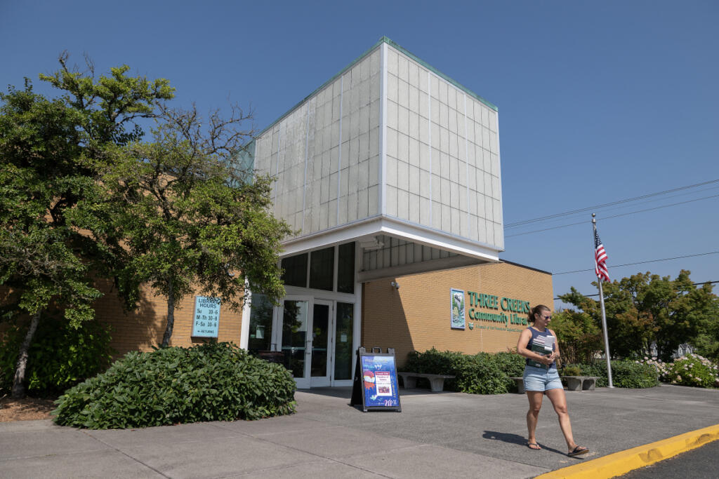 Lindsey Sinner of Felida leaves Three Creeks Community Library in Salmon Creek after checking out cookbooks Tuesday morning. (Amanda Cowan/ The Columbian)