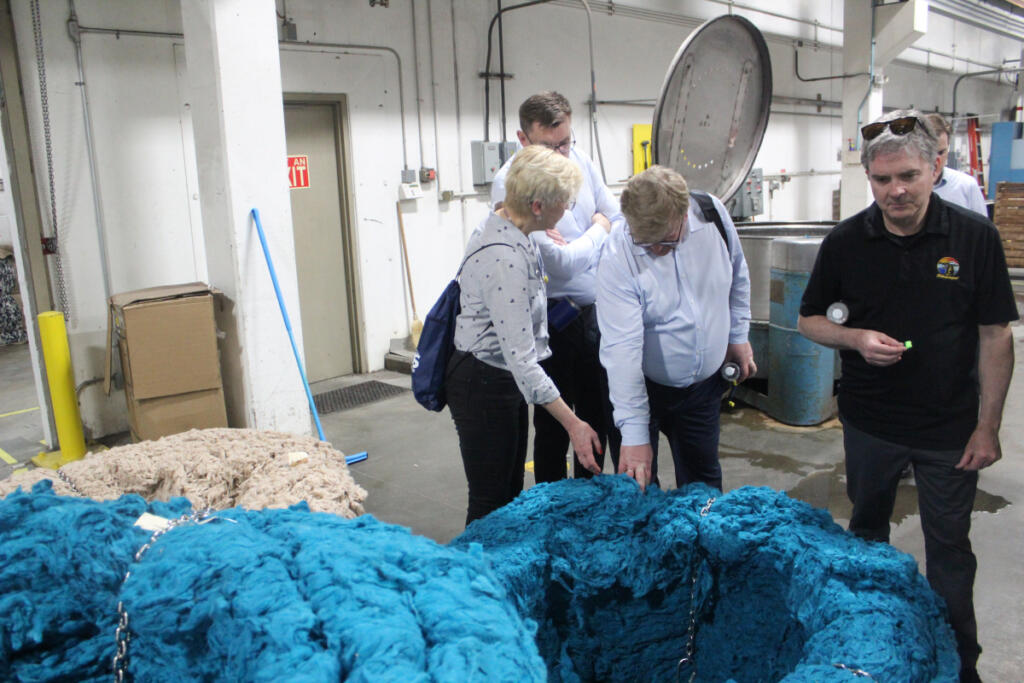 Washougal City Manager David Scott, right, looks at material during a tour of Pendleton Woolen Mills on April 26, 2023. (Contributed by City of Washougal)