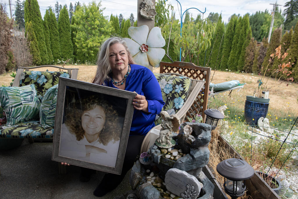 Christina Keys holds a photo of her late mother at her Vancouver home in July 2024. Keys defends WA Cares, which she said would have helped her care for her mother after a stroke. (amanda cowan/The Columbian files)