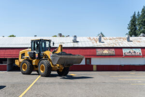 A construction vehicle moves around the food court area during setup for the 2025 Clark County Fair. The county council last week approved moving forward with financing $44 million in upgrades, including a new covered pavilion, food cart area and marquee sign. (Taylor Balkom/The Columbian files)