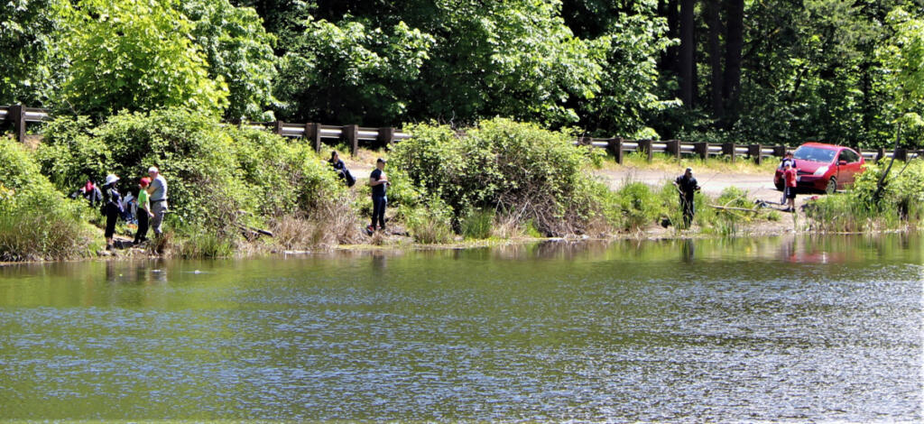 Anglers line the banks of Icehouse Lake in southwest Washington. Fishermen across the country are feeling the heat from animal rights groups that hope to eliminate the sport. (Terry Otto for The Columbian)