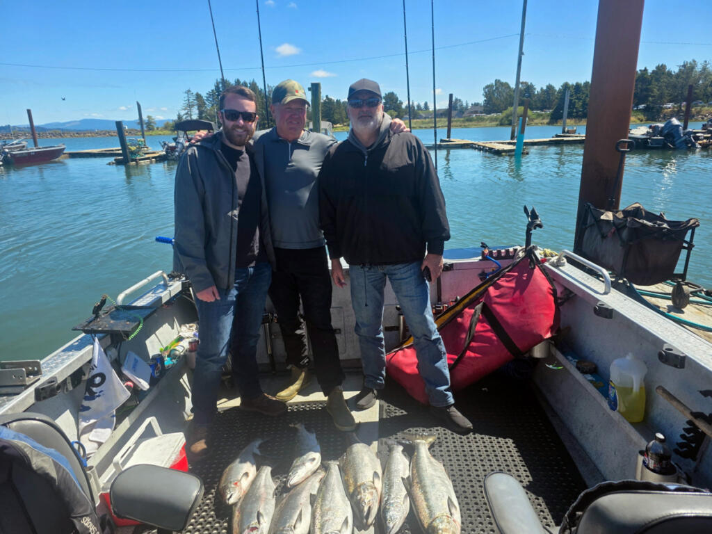 Three anglers pose with a mess of Buoy 10 salmon. Guides and anglers have been getting plenty of Chinook and coho in the estuary near Astoria, Ore., this month. (Photo courtesy of Marvin&rsquo;s Guide Service)