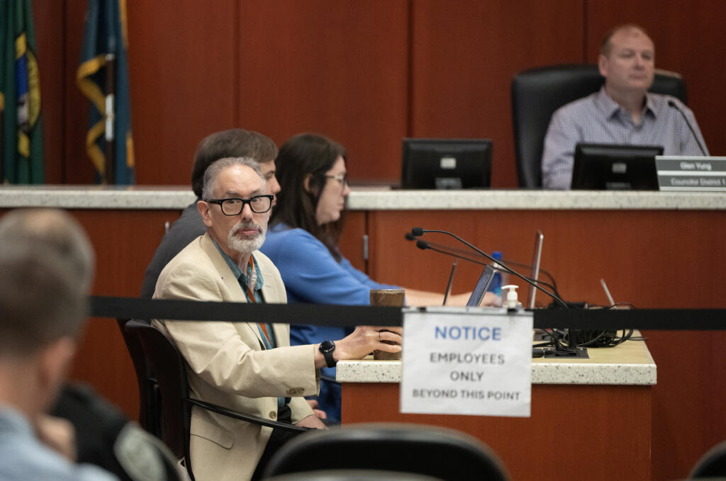 Dr. Alan Melnick, left, attends a Clark County Board of Health meeting at the Public Service Center on June 24. (Amanda Cowan/The Columbian files)
