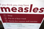 An informational sign about the measles is posted in the entrance of the Kaiser Permanente Cascade Park office Feb. 4, 2019. (Amanda Cowan/The Columbian files)