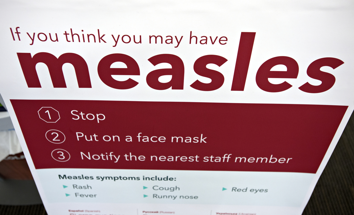 An informational sign about the measles is posted in the entrance of the Kaiser Permanente Cascade Park office Feb. 4, 2019. (Amanda Cowan/The Columbian files)