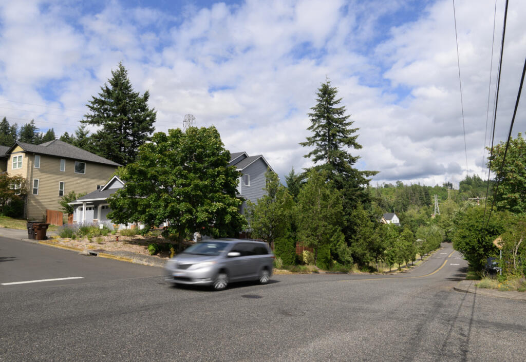 A car moves through the intersection of W and 42nd streets on June 30 in Washougal. Resident Tim Taylor has been fighting to get speeding under control along W Street since 2021. (Taylor Balkom/The Columbian)