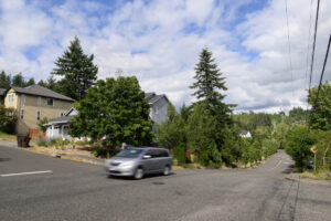 A car moves through the intersection of W and 42nd streets on June 30 in Washougal. Resident Tim Taylor has been fighting to get speeding under control along W Street since 2021. (Taylor Balkom/The Columbian)