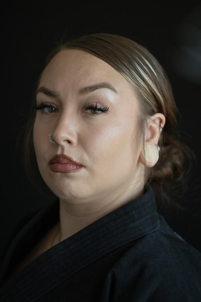 Malia Cropper takes a break at Cropper Martial Arts and Fitness in Camas on July 14. Cropper is preparing to open a martial arts school in Camas as she prepares to defend her title this fall in Puerto Rico. (Amanda Cowan/The Columbian)
