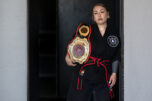 Malia Cropper takes a break at Cropper Martial Arts and Fitness in Camas with her 2025 KSDI World Championship belt July 14. (Amanda Cowan/The Columbian)