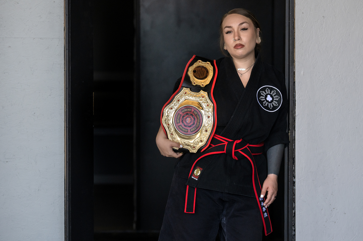 Malia Cropper takes a break at Cropper Martial Arts and Fitness in Camas with her 2025 KSDI World Championship belt July 14. (Amanda Cowan/The Columbian)