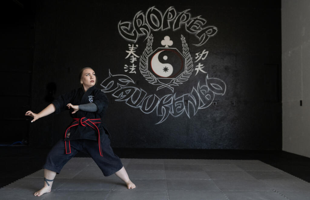 Malia Cropper takes a break at Cropper Martial Arts and Fitness in Camas on July 14. Just months after winning a gold medal at the World Martial Arts Games in Oslo, Norway, Cropper is preparing to open a martial arts school in Camas as she prepares to defend her title this fall in Puerto Rico. (Photos by Amanda Cowan/The Columbian)