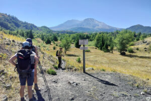Hikers get ready for adventure at the spot where Boundary Trail no. 1 veers away from the Hummocks loop trail. Mount St. Helens looms in the distance. (Scott Hewitt/The Columbian)