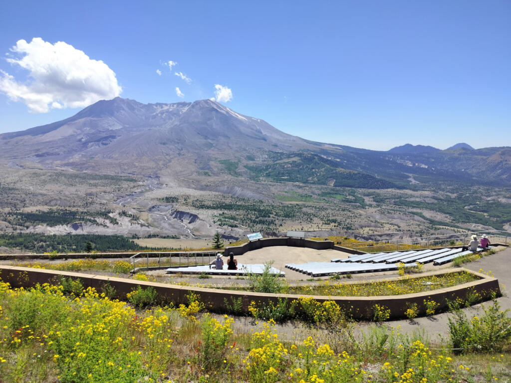 Hikers who&rsquo;ve made the climb to Johnston Ridge relax in an outdoor amphitheater facing the volcano. (Scott Hewitt/The Columbian)