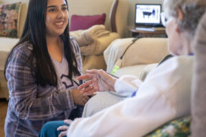 Home Instead caregiver Andrea Salinas, left, checks client Betty Tribe&rsquo;s vital signs on July 30 at Tribe&rsquo;s home in Ridgefield. (Taylor Balkom/The Columbian)