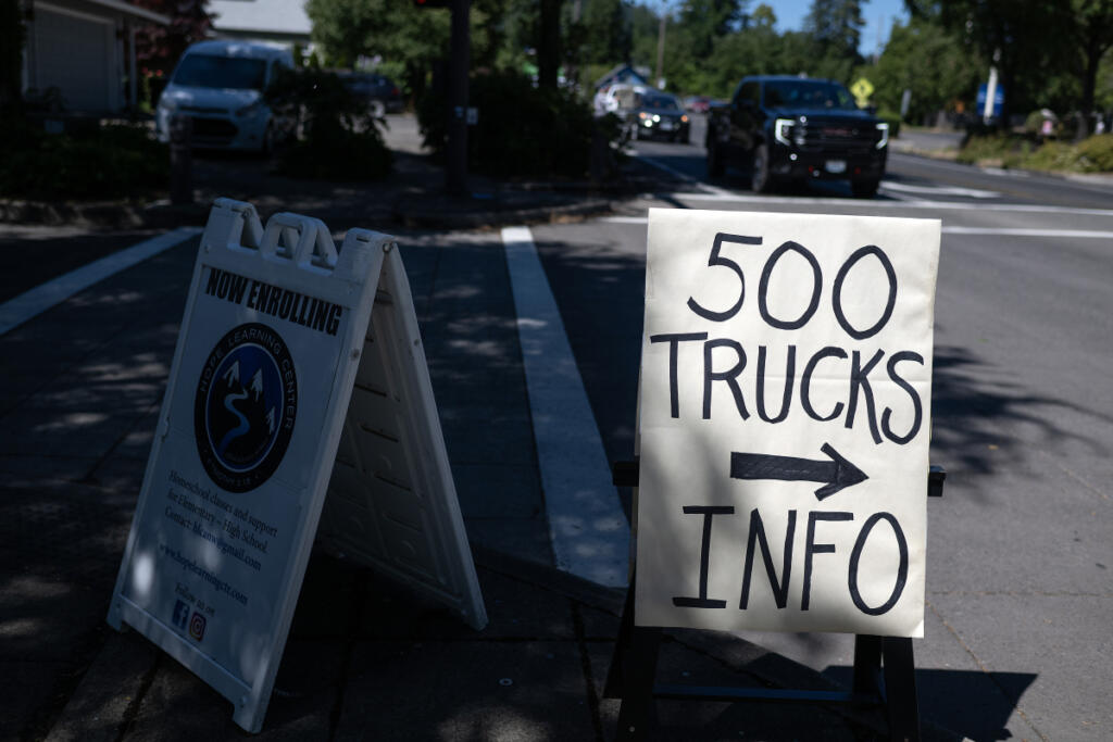 Signs raise alarms about the 500 daily truck trips anticipated from a proposed gravel mine. (Amanda Cowan/The Columbian)