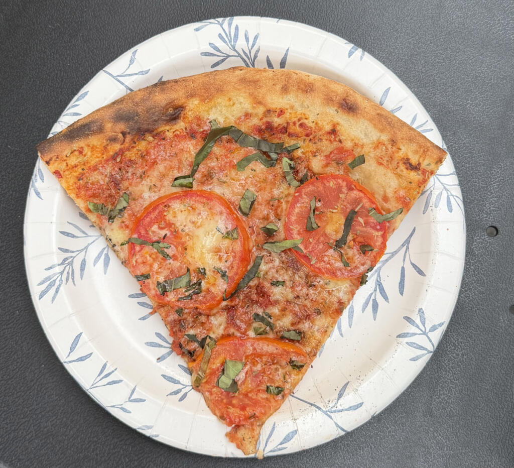 Pizza from Peace&rsquo;a Planet offers fire-kissed crust layered with sweet, zesty sauce. (Rachel Pinsky)