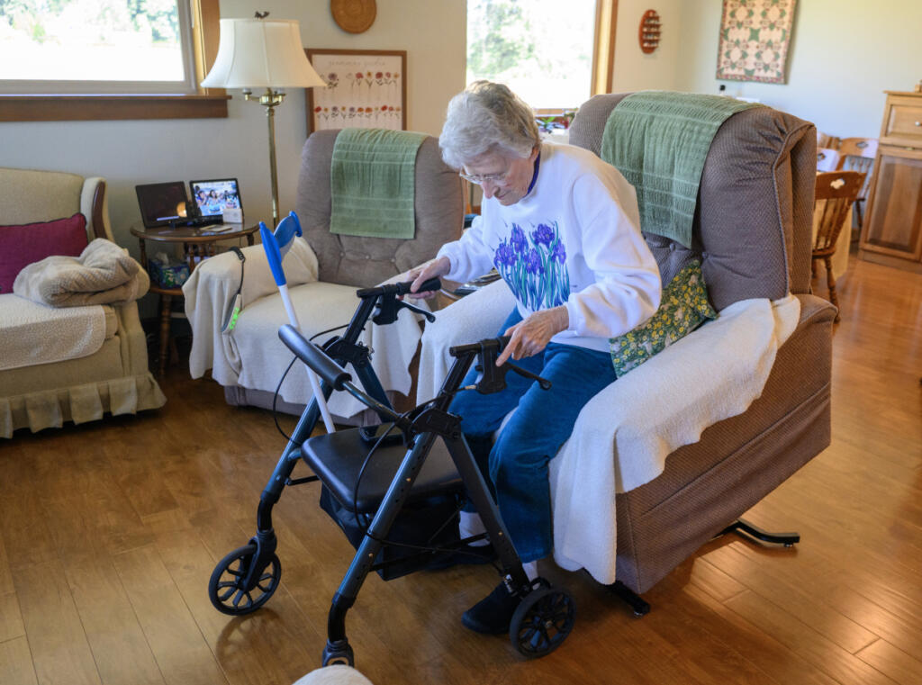 Betty Tribe demonstrates her electric recliner that can assist her in standing up July 30 in Ridgefield. (Taylor Balkom/The Columbian)