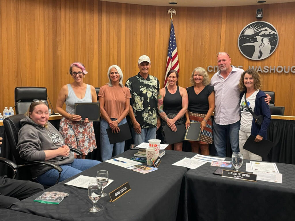 Washougal Mayor David Stuebe, second from right, and Councilor Tia Robertson, far left, pose for a photo during a July 27 council meeting with Harlan Nelson, fourth from left, and the group of people who helped Nelson at Hathaway Park on July 15. (Photo contributed by Lynda Boesel)