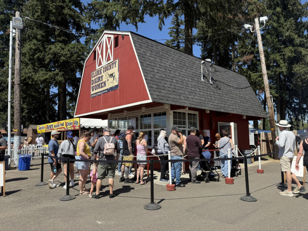 The Clark County Dairy Women booth with a long line wrapped around it. The popular stop sells milkshakes, sundaes and ice cream. (Kimberly Cortez/The Columbian)