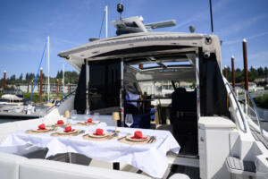 A set table sits at the rear of the Lux X Charters yacht Ventidue on Monday at Tidewater Cove Marina.