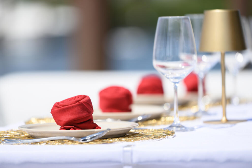 Napkins formed into roses sit at a dining table Monday aboard the Lux X Charters yacht Ventidue at Tidewater Cove Marina. (Taylor Balkom/The Columbian)