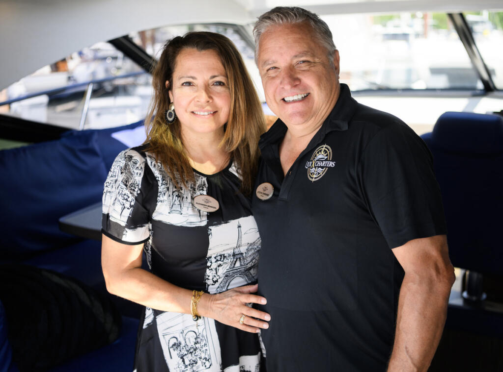 Lux X Charters co-owners Alexandra Mendoza, left, and Steve Ehrsam stand for a portrait Monday aboard the yacht Ventidue at Tidewater Cove Marina.