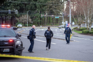 Vancouver police officers rope off a crime scene March 4, 2025, after a shooting near Fort Vancouver Way and Fourth Plain Boulevard. Crime in Vancouver fell between 2024 and 2025, according to a new state report. (Taylor Balkom/The Columbian files)