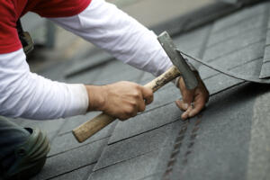 A roofer hand nails shingles Oct. 19, 2012, in Vancouver. Several roofing companies in the Portland area have been acquired by private equity firms in recent years. (The Columbian files)