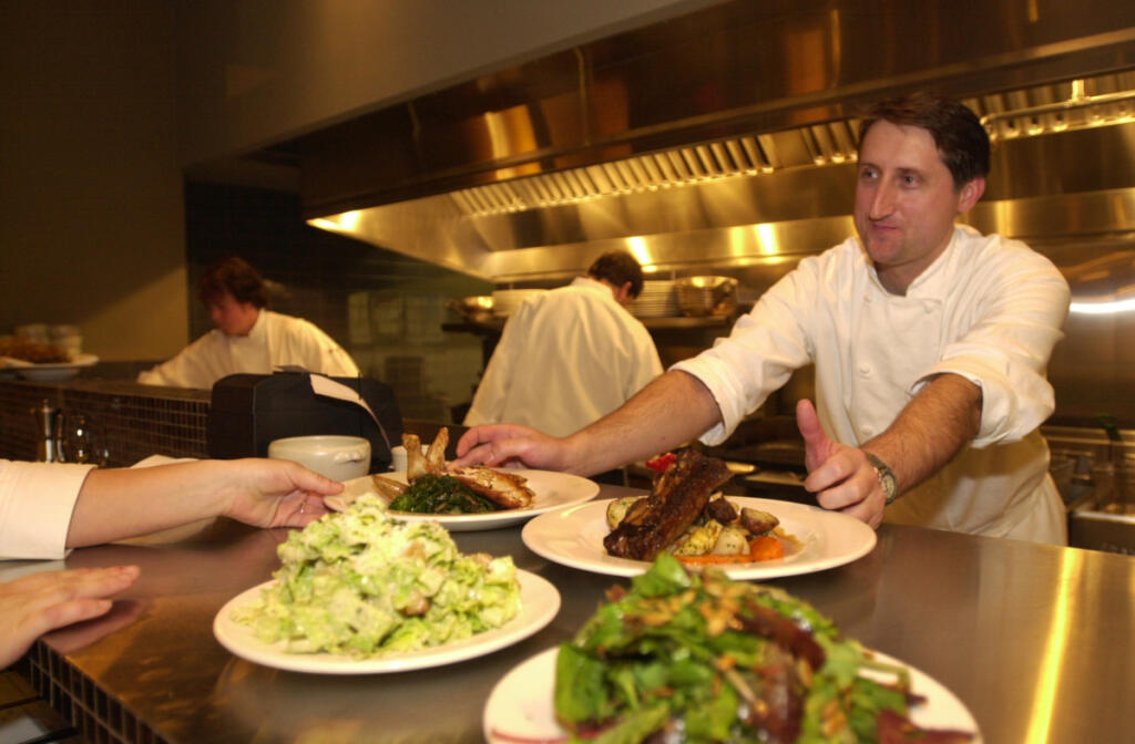 Executive Chef Brad Root presents food to servers at Roots Restaurant and Bar in 2003. (The Columbian file photos)