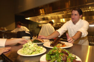 Executive Chef Brad Root presents food to servers at Roots Restaurant and Bar in 2003. (The Columbian file photos)