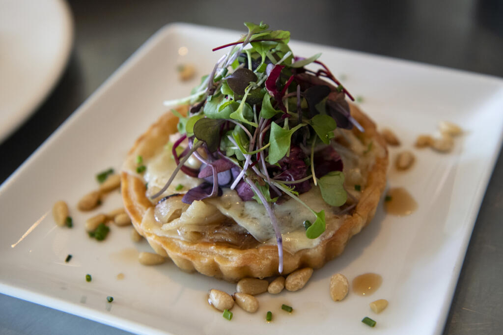 A Walla Walla sweet onion tart is pictured in 2021 at Roots Restaurant and Bar in Camas. (The Columbian files)