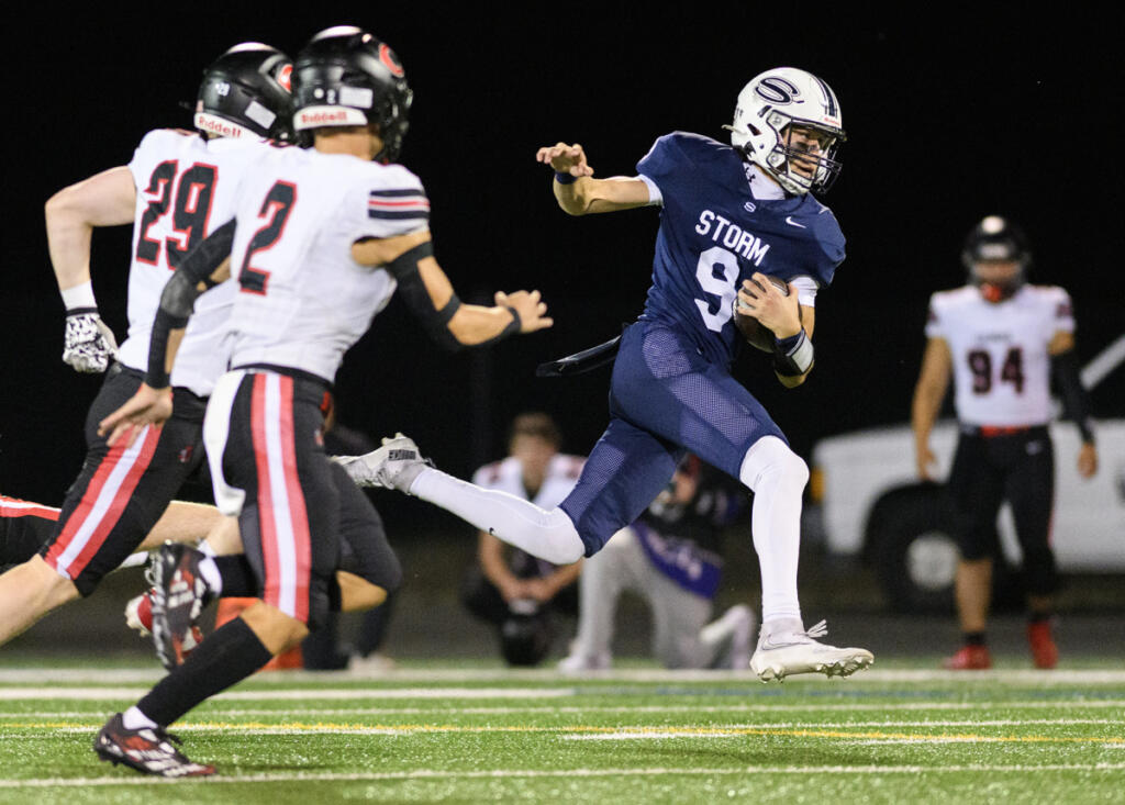 Skyview senior Dugan Logue (9) evades tacklers Friday, during Skyview&rsquo;s 38-21 win against Camas at Kiggins Bowl. (Photos by Taylor Balkom/The Columbian)
