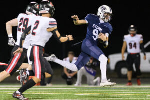 Skyview senior Dugan Logue (9) evades tacklers Friday, during Skyview&rsquo;s 38-21 win against Camas at Kiggins Bowl. (Photos by Taylor Balkom/The Columbian)