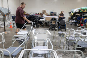William Hobson of Vancouver, left, looks over the items available to be checked out at A Caring Closet on Sept. 1. A Caring Closet provides free durable medical equipment, such as walkers, wheelchairs and shower chairs, to people in need. (Photos by Amanda Cowan/The Columbian)