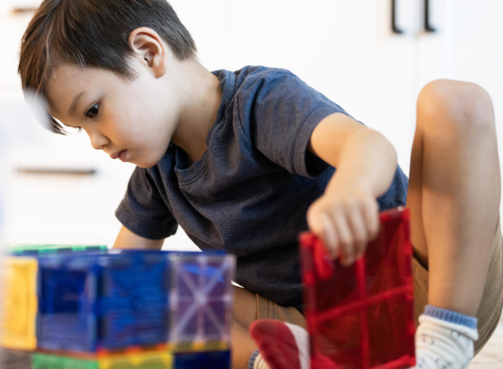 Theodore Wiener, 5, plays with magnetic building squares Aug. 25 at the Wiener residence in Camas. Theodore was diagnosed with adrenoleukodystrophy, a rare genetic disease that can cause devastating neurological and adrenal damage. (Taylor Balkom/The Columbian)