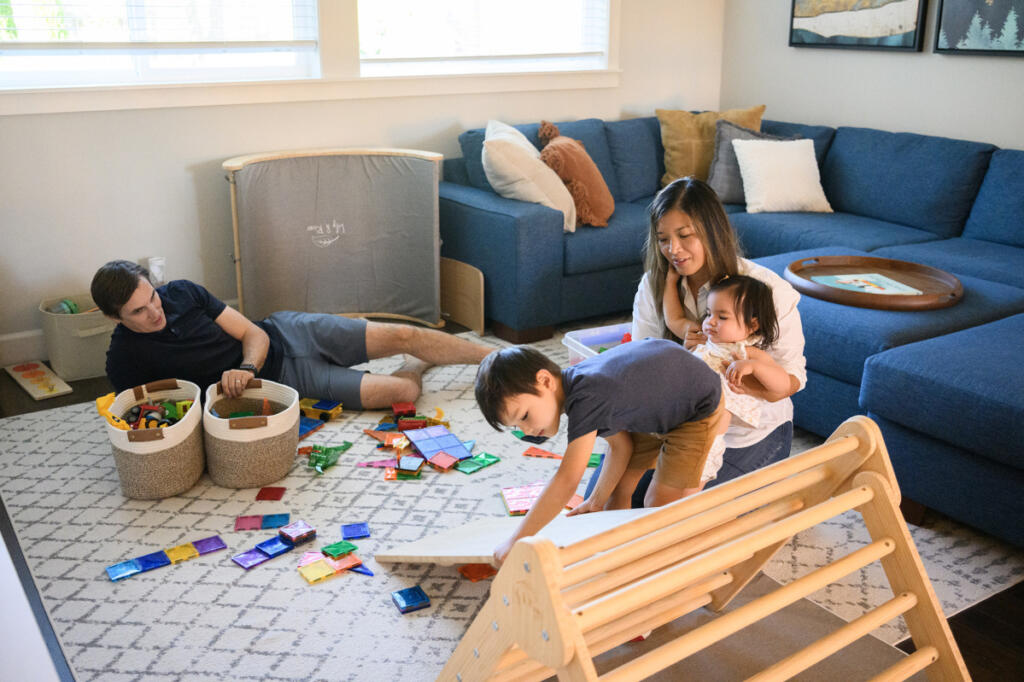 The Wiener family &mdash; Adam, clockwise from left, Terry, Ella, 1, and Theodore, 5 &mdash; hang out Tuesday at their home in Camas. Terry and Adam Wiener founded Cure ALD after their son, Theodore, was diagnosed with adrenoleukodystrophy, a rare genetic disease that can cause devastating neurological and adrenal damage. (Taylor Balkom/The Columbian)