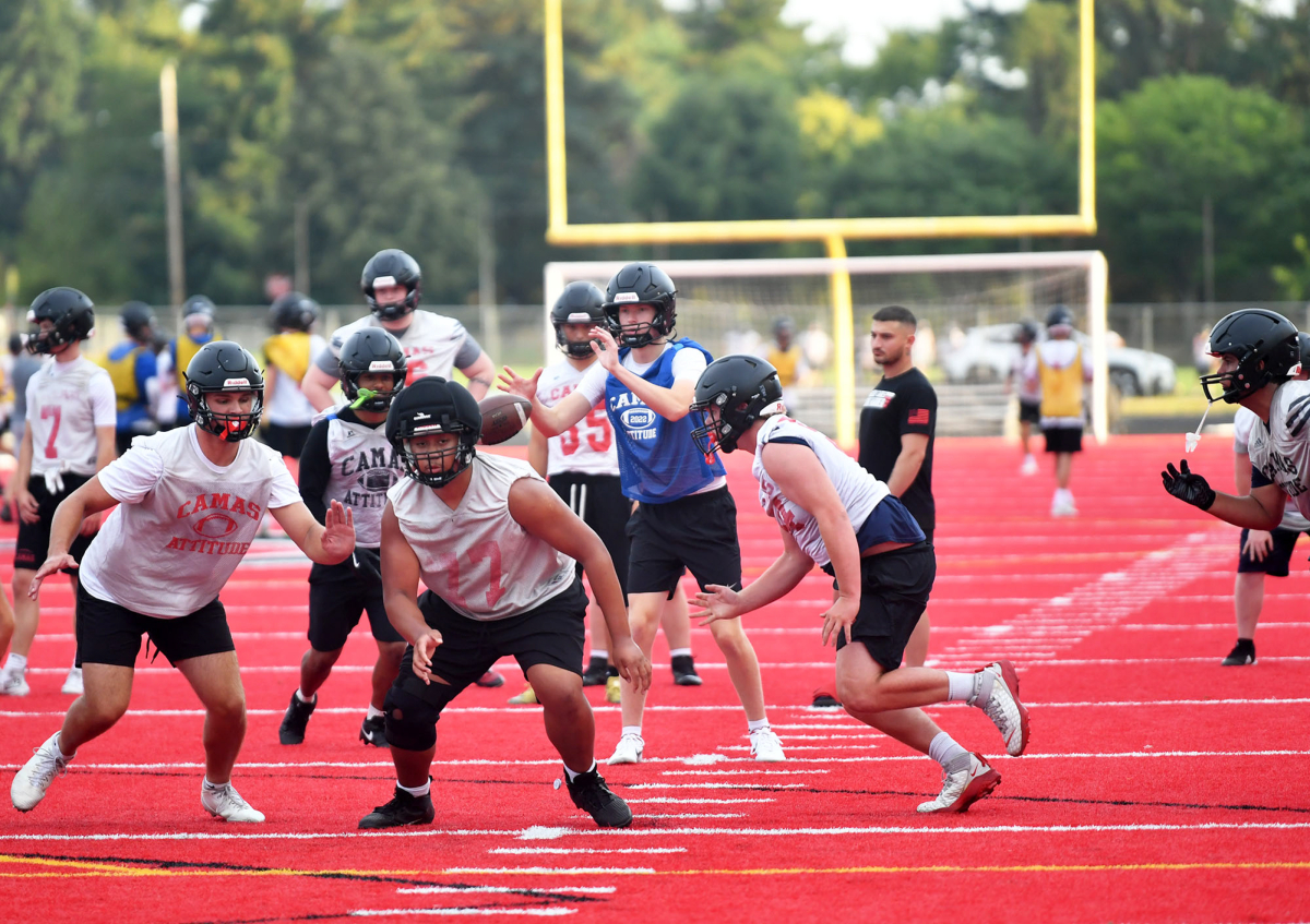 Camas players run through a play during a football practice at Camas High School&rsquo;s Cardon Field. Camas will host Chiawana in its opener. (Tim Martinez/The Columbian)
