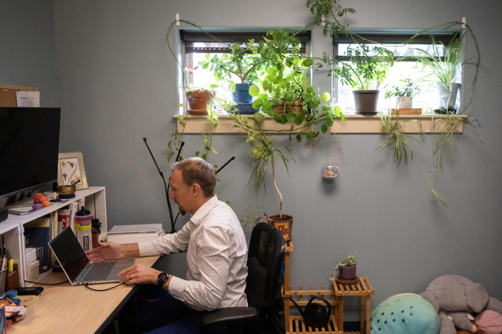Child and family therapist Christopher Banke sits at his desk Thursday at his office in the Children&rsquo;s Center. (Taylor Balkom/The Columbian)