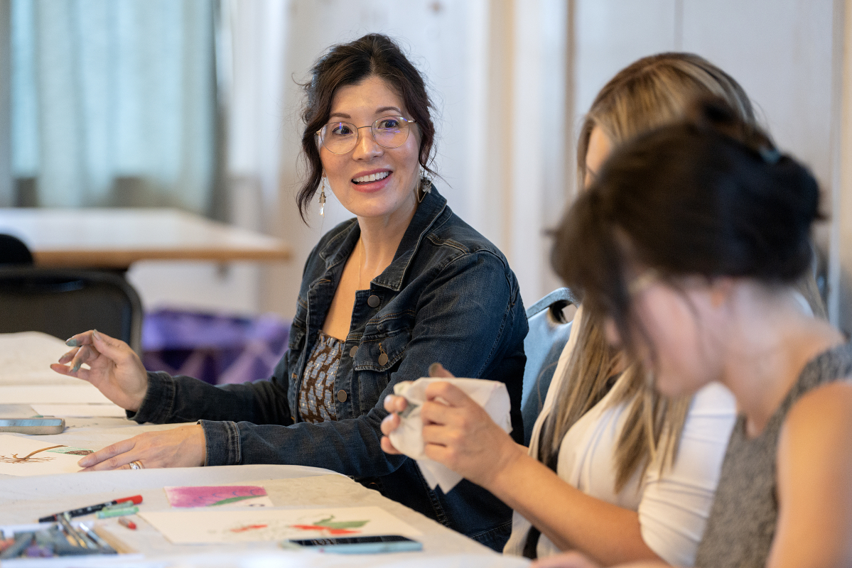 Camas artist Jilleen Shahidi, left, chats with participants Sept. 1 during Memory Garden, a monthly art meetup for adults at Camas Community Center. (Amanda Cowan/The Columbian)
