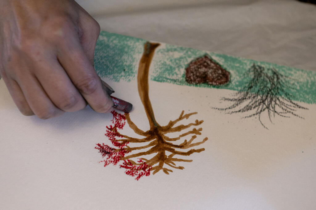 Camas artist Jilleen Shahidi works with participants Sept. 1 during Memory Garden, a free monthly art meetup for adults at Camas Community Center. Creativity improves mental and emotional health and this meetup is also a social occasion. (Amanda Cowan/The Columbian)